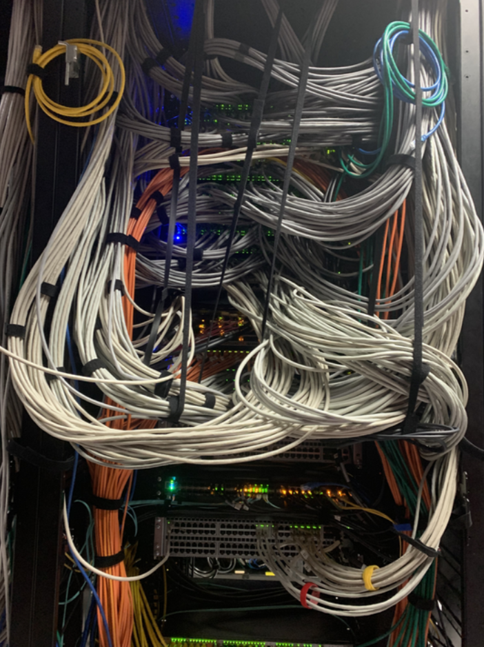 An image of cables connected to network switches in a data center.