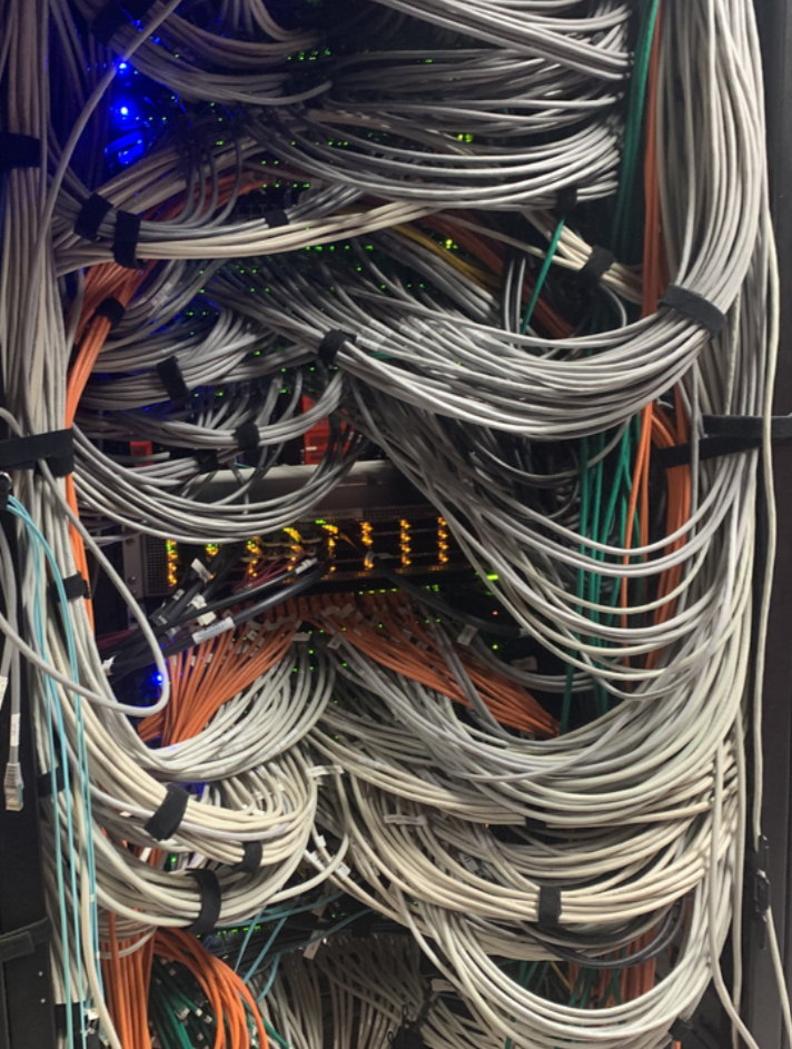 An image of network cables in a data center rack.