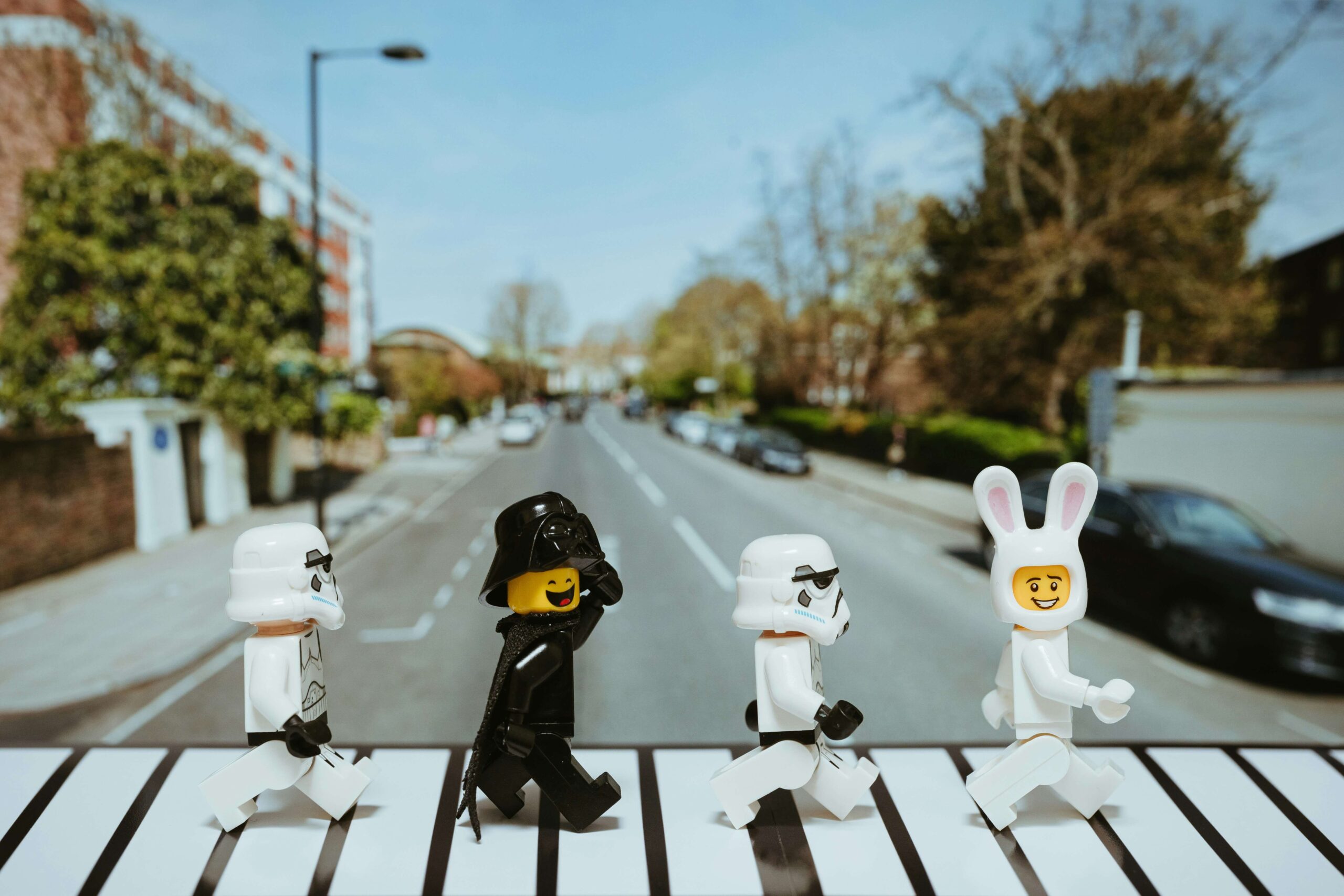 A photo showing various Lego Star Wars figurines posing in a crosswalk that is a reference to the Beatles' Abbey Road album cover. 
